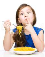 Little girl is eating spaghetti