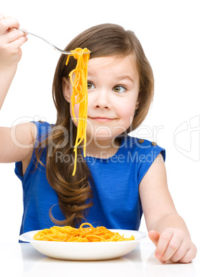 Little girl is eating spaghetti