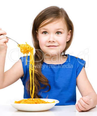 Little girl is eating spaghetti