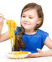Little girl is eating spaghetti