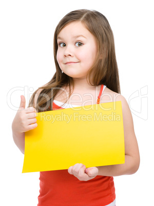 Little girl is holding blank yellow banner