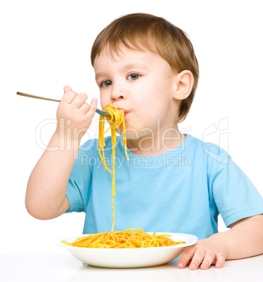 Little boy is eating spaghetti