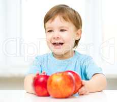 Portrait of a happy little boy with apple