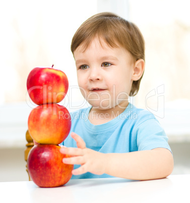 Portrait of a little boy with apples