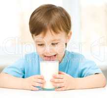 Cute little boy with a glass of milk