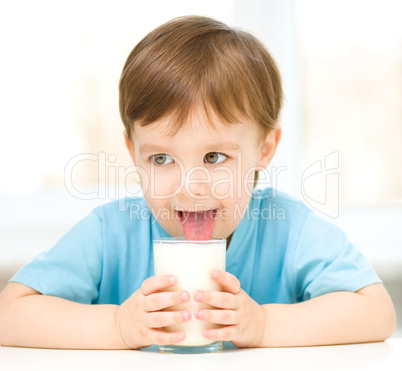 Cute little boy with a glass of milk