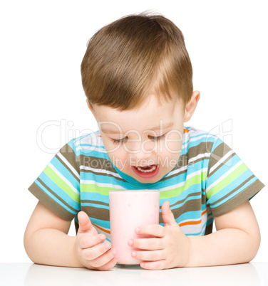 Cute little boy with a glass of milk