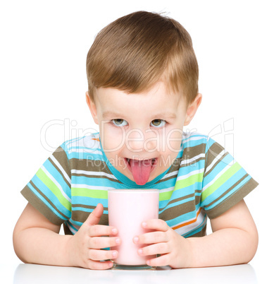 Cute little boy with a glass of milk
