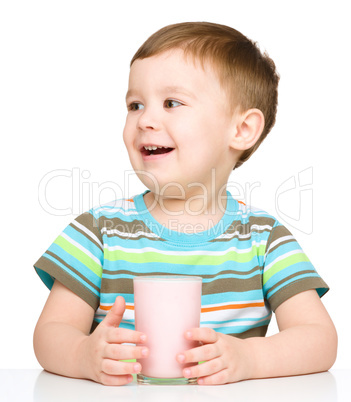 Cute little boy with a glass of milk