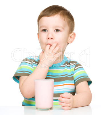 Cute little boy with a glass of milk