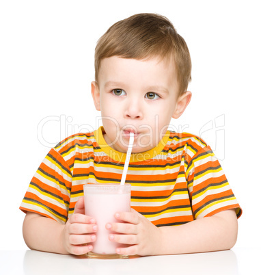 Cute little boy with a glass of milk