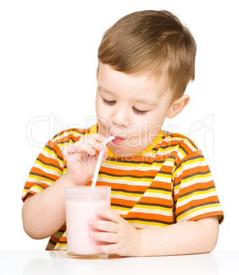 Cute little boy with a glass of milk