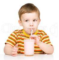 Cute little boy with a glass of milk