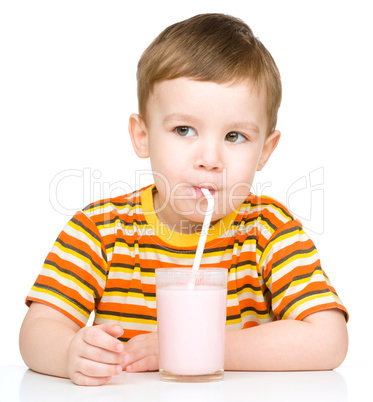 Cute little boy with a glass of milk