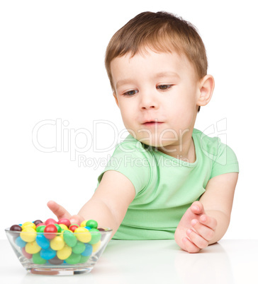 Little boy refusing to eat candies