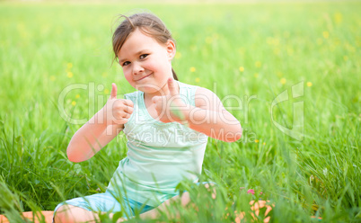 Little girl is showing thumb up gesture