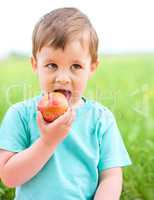 Portrait of a little boy with apple
