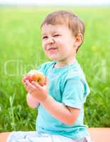 Portrait of a happy little boy with apple