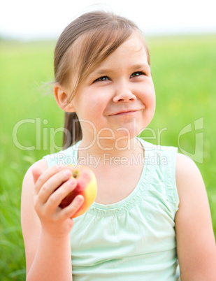 Portrait of a little girl with apple