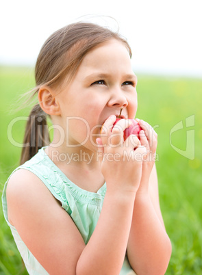 Portrait of a little girl with apple