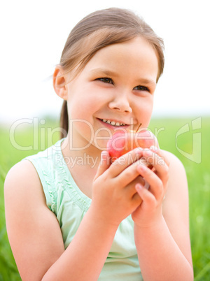 Portrait of a little girl with apple