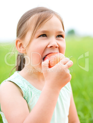 Portrait of a little girl with apple