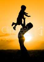 Silhouette of mother playing with her son