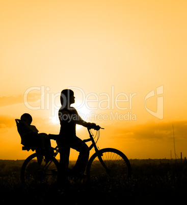 Mother riding on a bicycle with her child