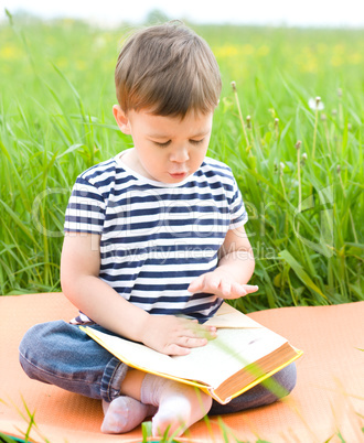 Little boy is reading book