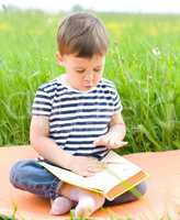 Little boy is reading book