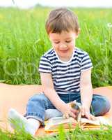 Little boy is reading book