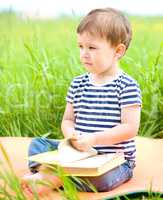 Little boy is reading book