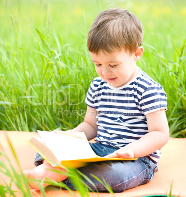 Little boy is reading book