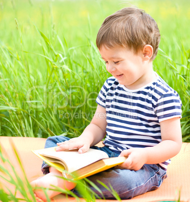 Little boy is reading book