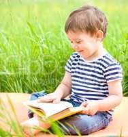 Little boy is reading book