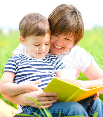 Mother is reading book for her child