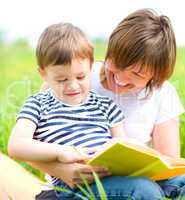 Mother is reading book for her child