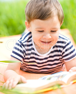 Little boy is reading book