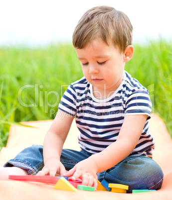 Little boy is playing with toys