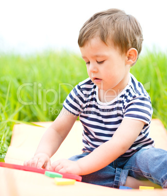 Little boy is playing with toys