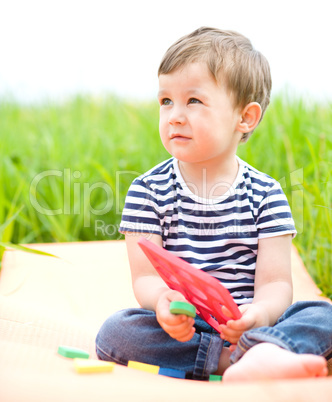 Little boy is playing with toys