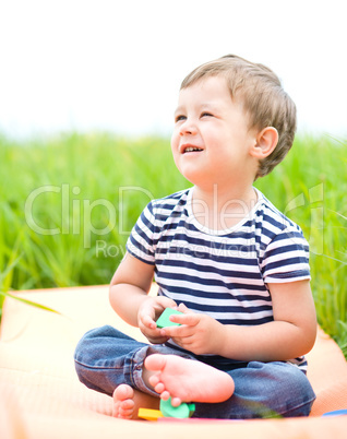 Little boy is playing with toys