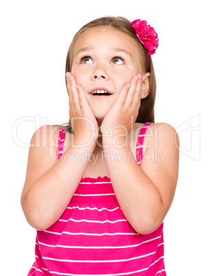Little girl is holding her face in astonishment
