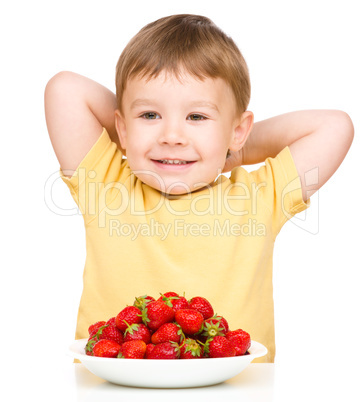 Happy little boy with strawberries