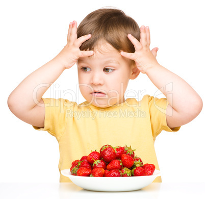 Little boy refuses to eat strawberries