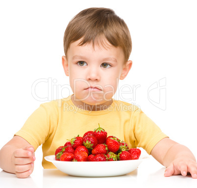 Little boy refuses to eat strawberries
