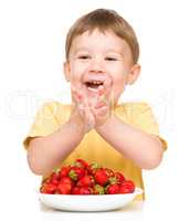 Little boy with strawberries