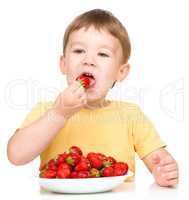 Little boy with strawberries