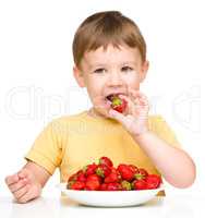 Little boy with strawberries