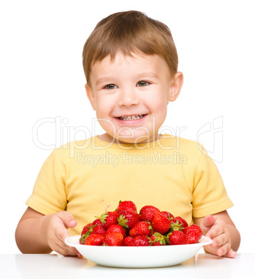 Little boy with strawberries